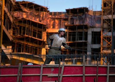 A Chinese construction worker sets rebar on an apartment building under construction as a development and a real estate boom takes hold in Ulaanbaatar, Mongolia, in October 2012. (Paula Bronstein/Getty Images)