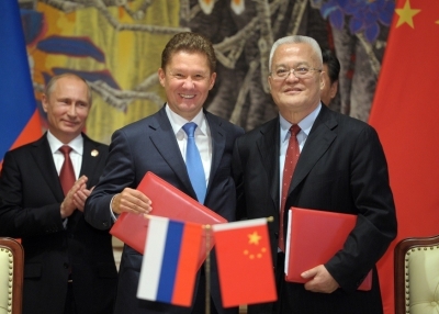 Russia's President Vladimir Putin (L) applauds during the agreement signing ceremony in Shanghai on May 21, 2014, with Gazprom CEO Alexei Miller (C) and Chinese state energy giant CNPC Chairman Zhou Jiping (R) attending the ceremony. (Alexey Druzhinin/AFP/Getty Images)