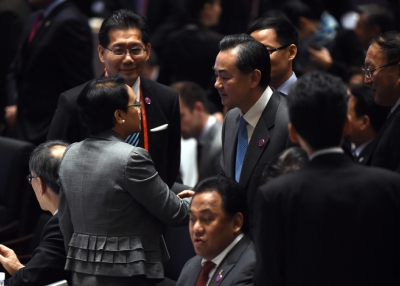 China’s Foreign Minister Wang Yi (center R) shakes hands with Indonesia’s Foreign Minister Retno Marsudi (front L) during the Asia-Pacific Economic Cooperation (APEC) Summit at the China National Convention Centre (CNCC) on November 7, 2014 in Beijing, China. (Greg Baker/Getty Images)