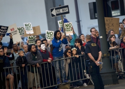 People protesting the Trans-Pacific Partnership (TPP) gather as US President Barack Obama attends a fund raiser for the Democratic National Committee at the Sentinel Hotel May 7, 2015 in Portland, Oregon. (Brendan Smialowski/AFP/Getty Images)