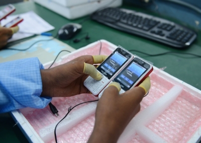 n Indian technician checks mobile phones at the Chinese Celkon Manufacturing plant at Medchal Mandal in the Rangareddy district on the outskirts of Hyderabad on June 26, 2015. (Noah Seelam/AFP/Getty Images)