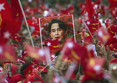 Supporters of Aung San Suu Kyi hold posters bearing her image as they listen to her speak during a campaign rally for the National League for Democracy in Yangon on November 1, 2015. (Ye Aung Thu/AFP/Getty Images)