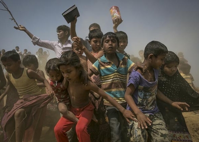 Rohingya refugees run to the crew of the Nautical Aliya as they provide relief supplies at the Balu Khali Rohingya refugee camp on February 15, 2017 in Chittagong, Bangladesh. (Allison Joyce/Getty Images)