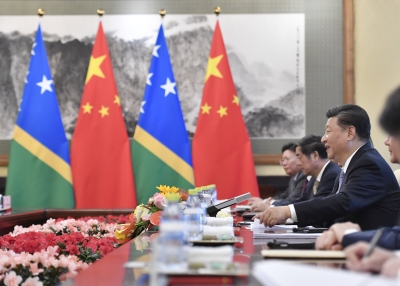 Chinese President Xi Jinping talks to Solomon Islands Prime Minister Manasseh Sogavare (not pictured) during their meeting at the Diaoyutai State Guesthouse in Beijing on October 9, 2019. 