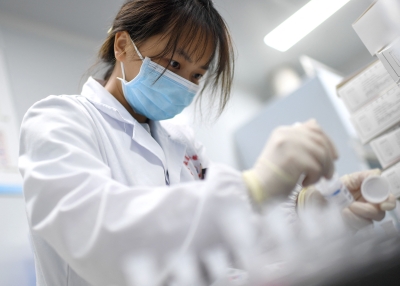 Laboratory technician conducting artificial intelligence (AI)-based cervical cancer screening at a test facility in Wuhan