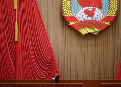 A staff member prepares for the closing session of the Chinese People's Political Consultative Conference (CPPCC) at the Great Hall of the People in Beijing on March 10, 2025. 