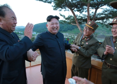 Kim Jong-Un reacting during a test launch of a Hwasong-12 missile