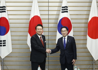 Yoon Suk Yeol, South Korea's president, left, and Fumio Kishida, Japan's prime minister, shake hands ahead of a summit meeting in 2023