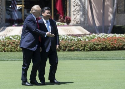 U.S. President Donald Trump and Chinese President Xi Jinping walk together at the Mar-a-Lago estate in West Palm Beach, Florida, April 7, 2017.