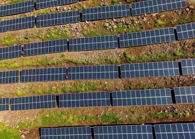 Chinese workers check solar photovoltaic modules on a hillside in a village in Chuzhou, in eastern China's Anhui province on April 13, 2017. (STR/AFP/Getty Images)